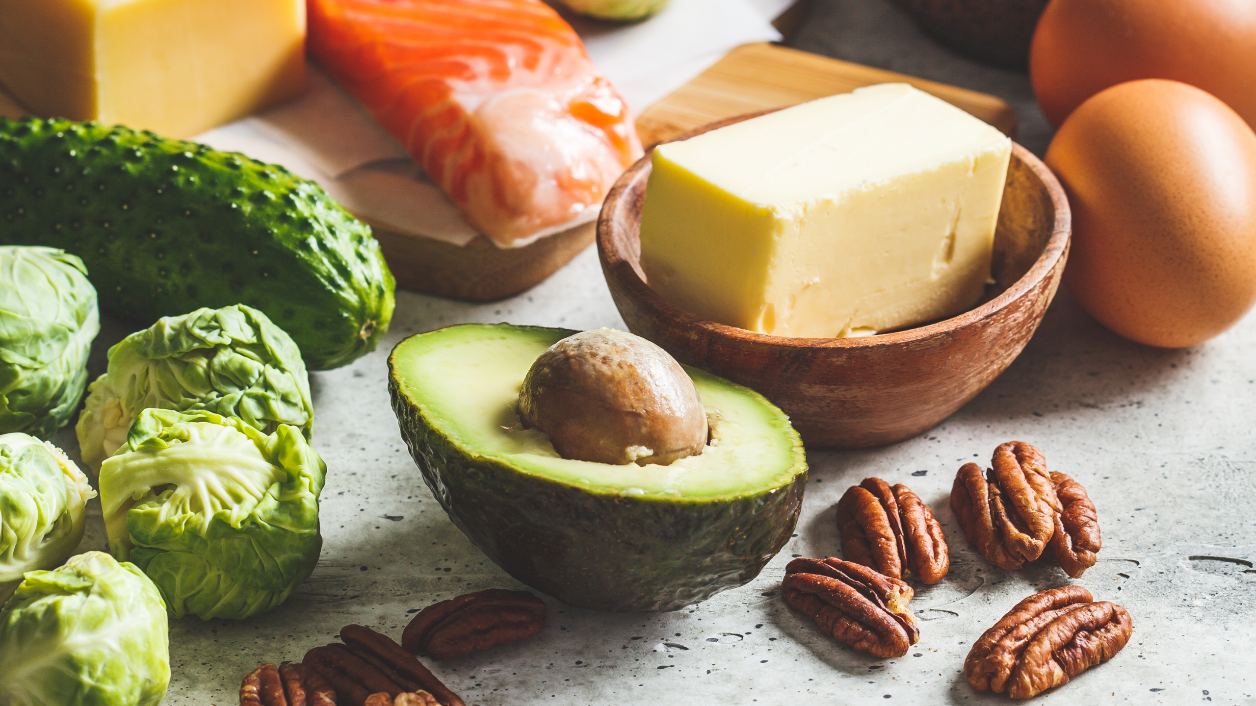 assortment of avocado, eggs, cheese, salmon and nuts