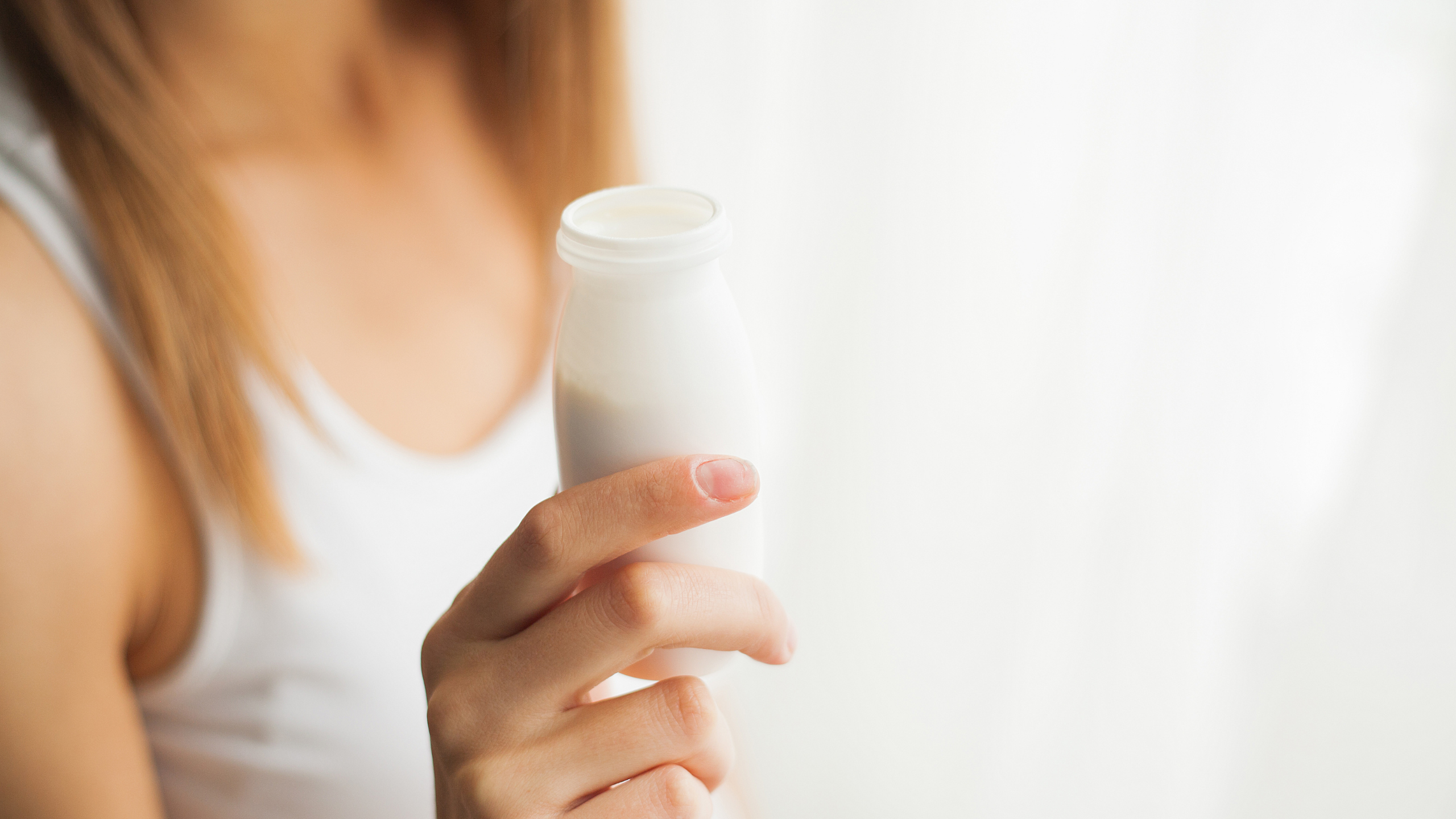 Woman holding probiotic drink