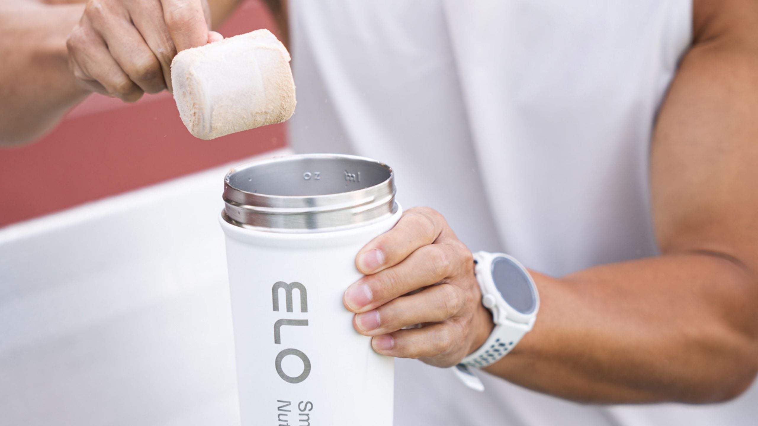 Chris pouring protein into shaker bottle