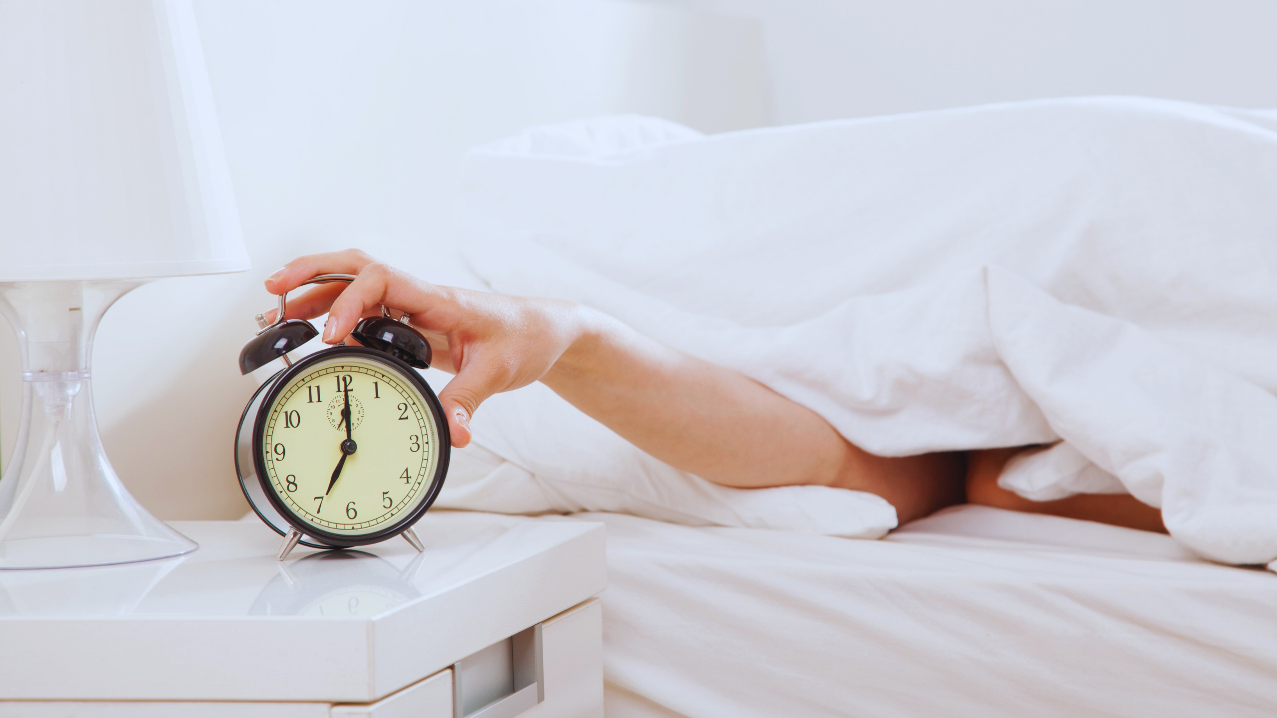 Man hitting alarm clock