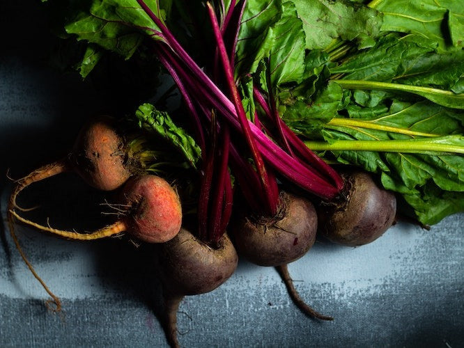Raw beets on a blue background