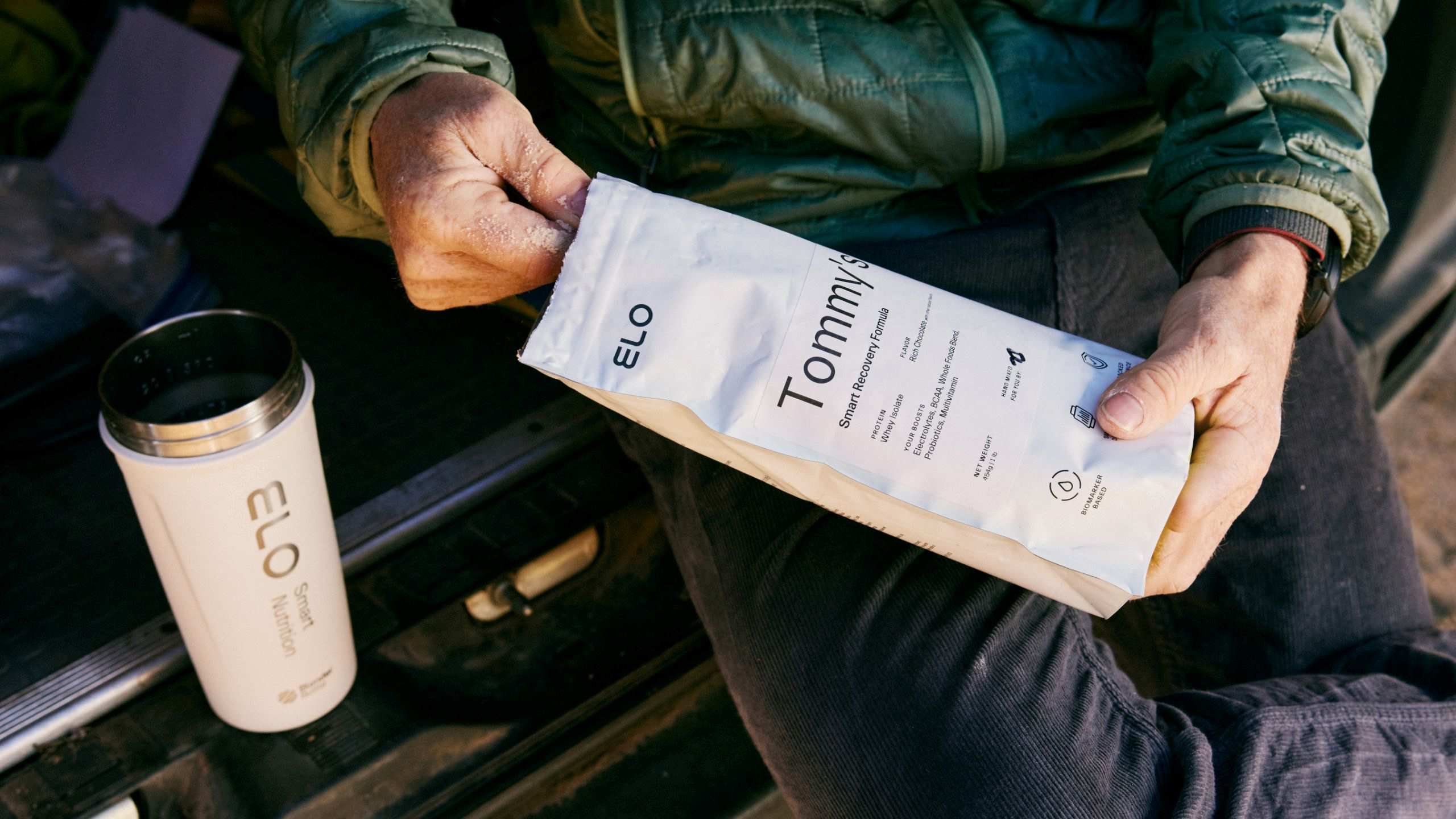 Tommy Caldwell scooping protein into shaker bottle