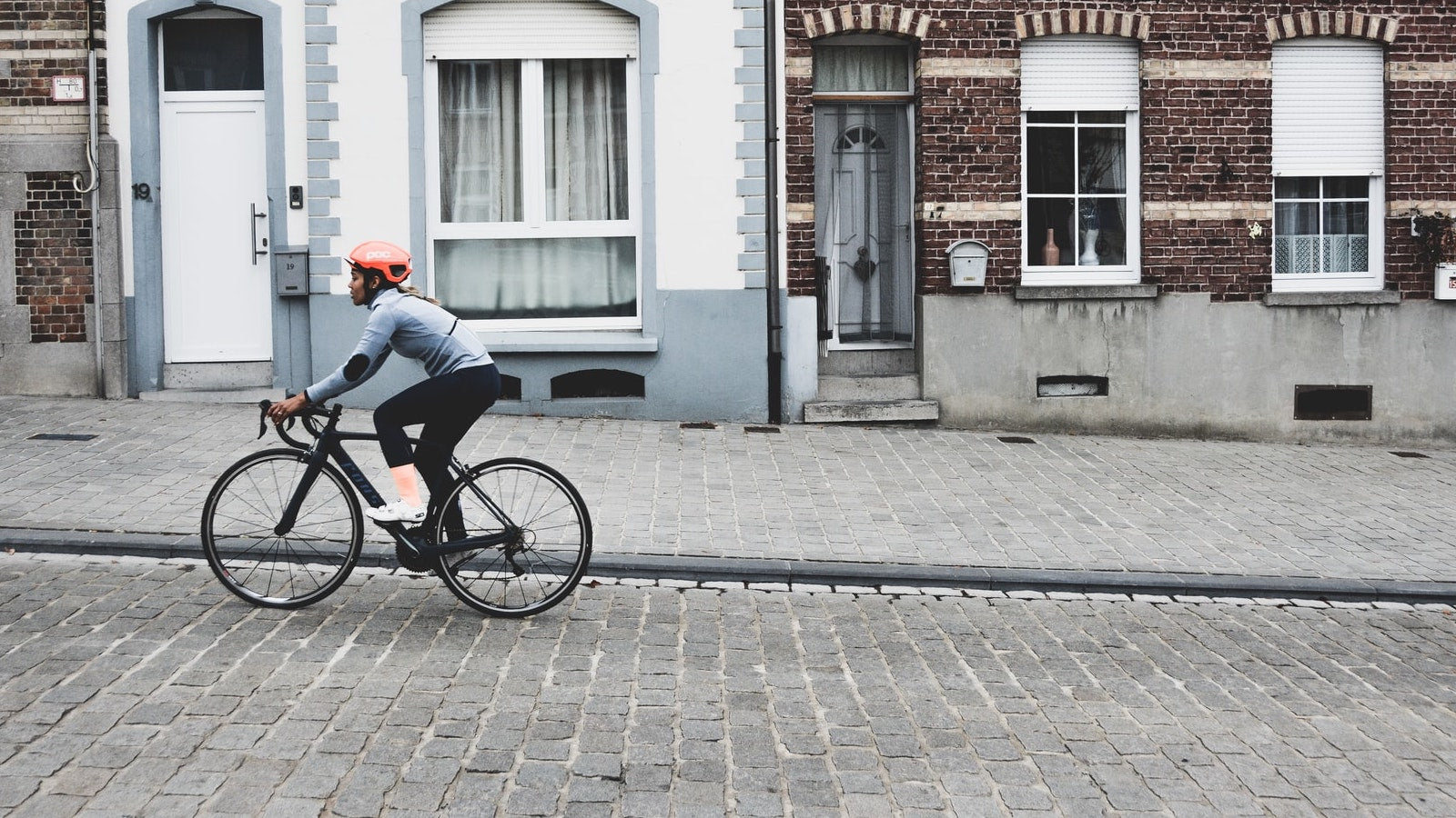 woman with orange helmet cycling