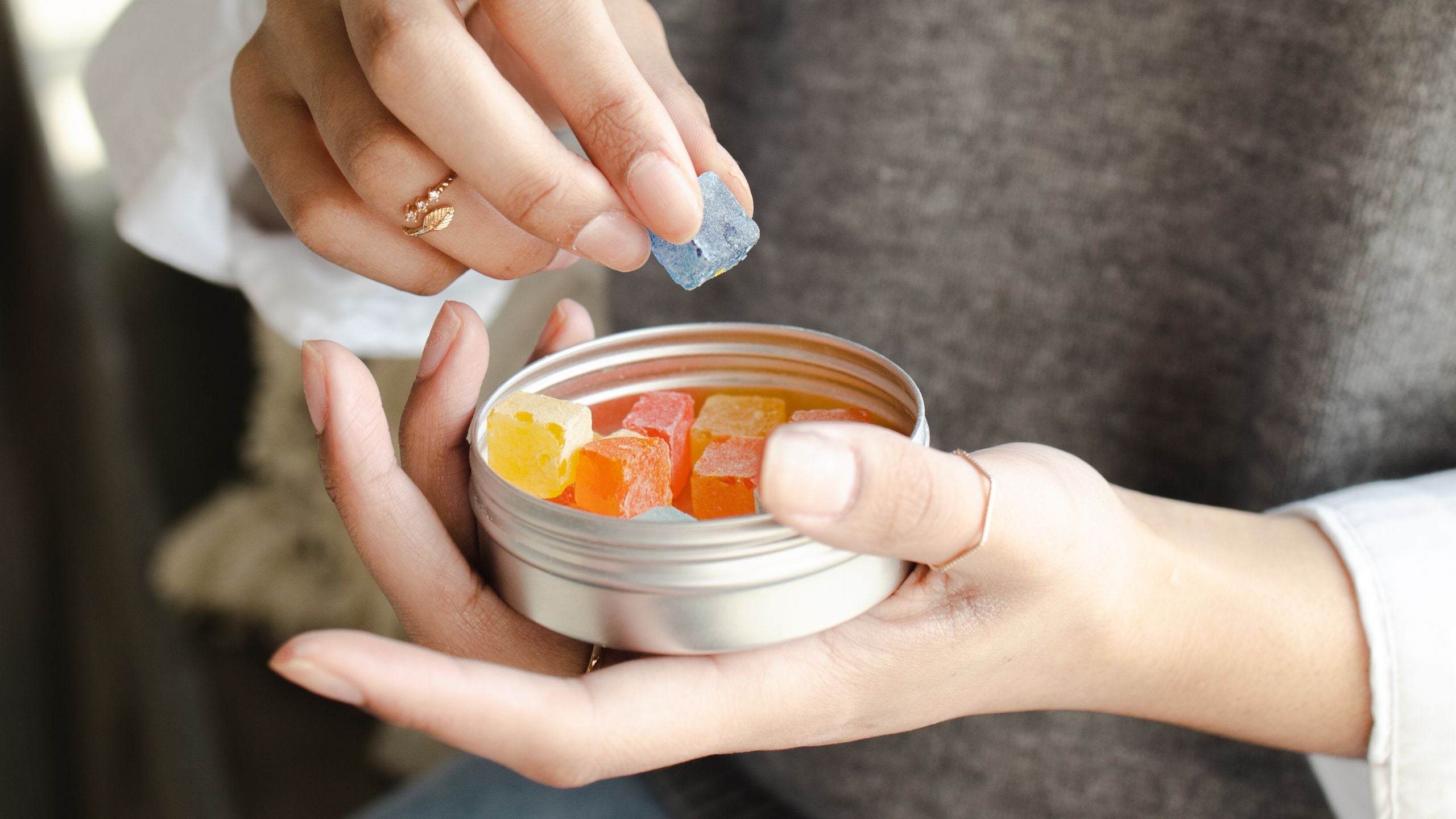 woman holding gummy vitamins