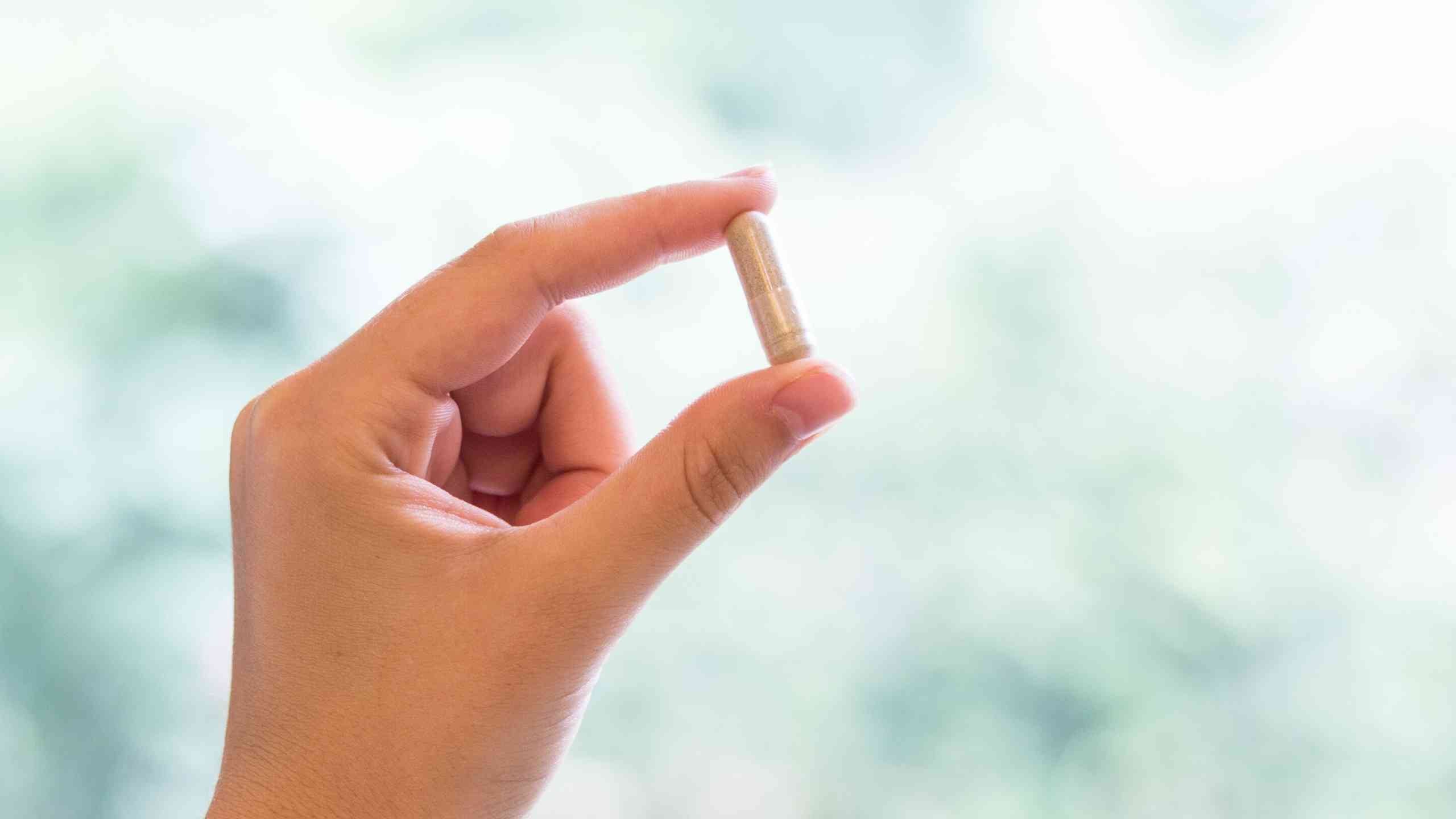 woman holding supplement