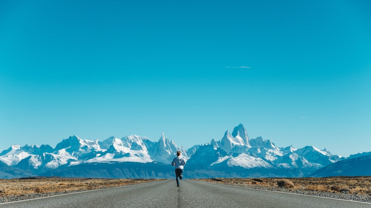 Man running toward mountains