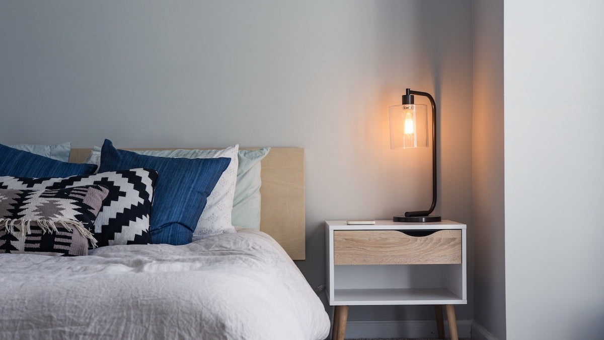 Bed with blue, white and black pillows