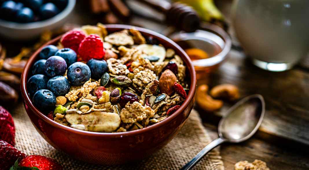 granola and fruit in a wooden bowl