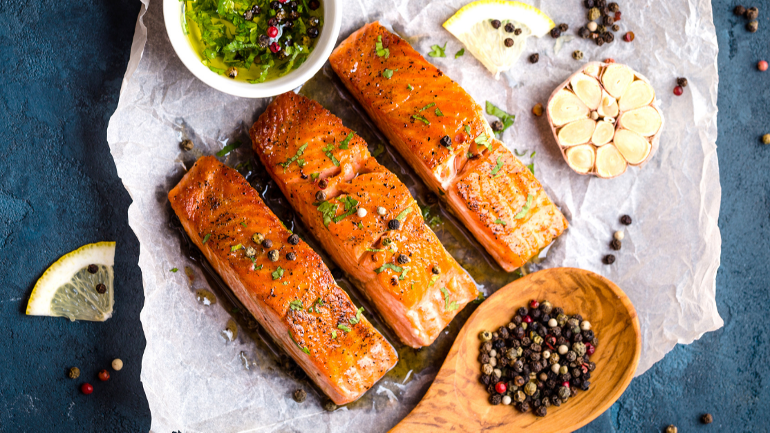 salmon filets with garlic and pesto in a bowl
