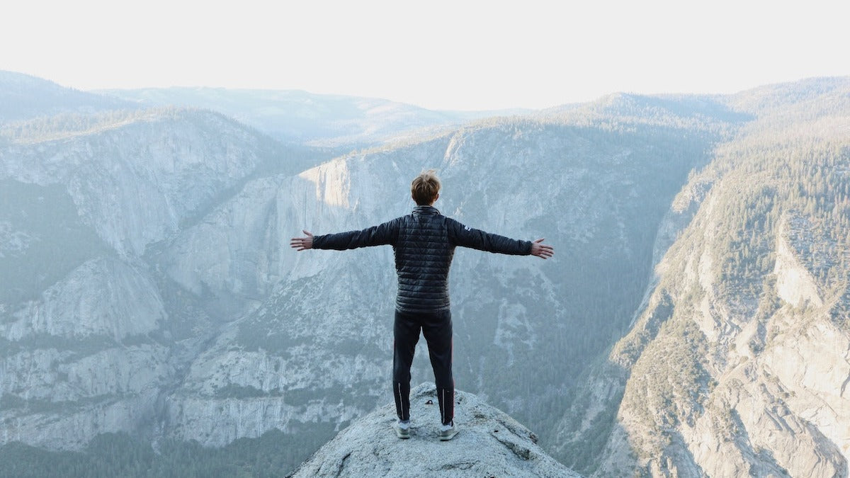 Man standing on a mountain looking at the view