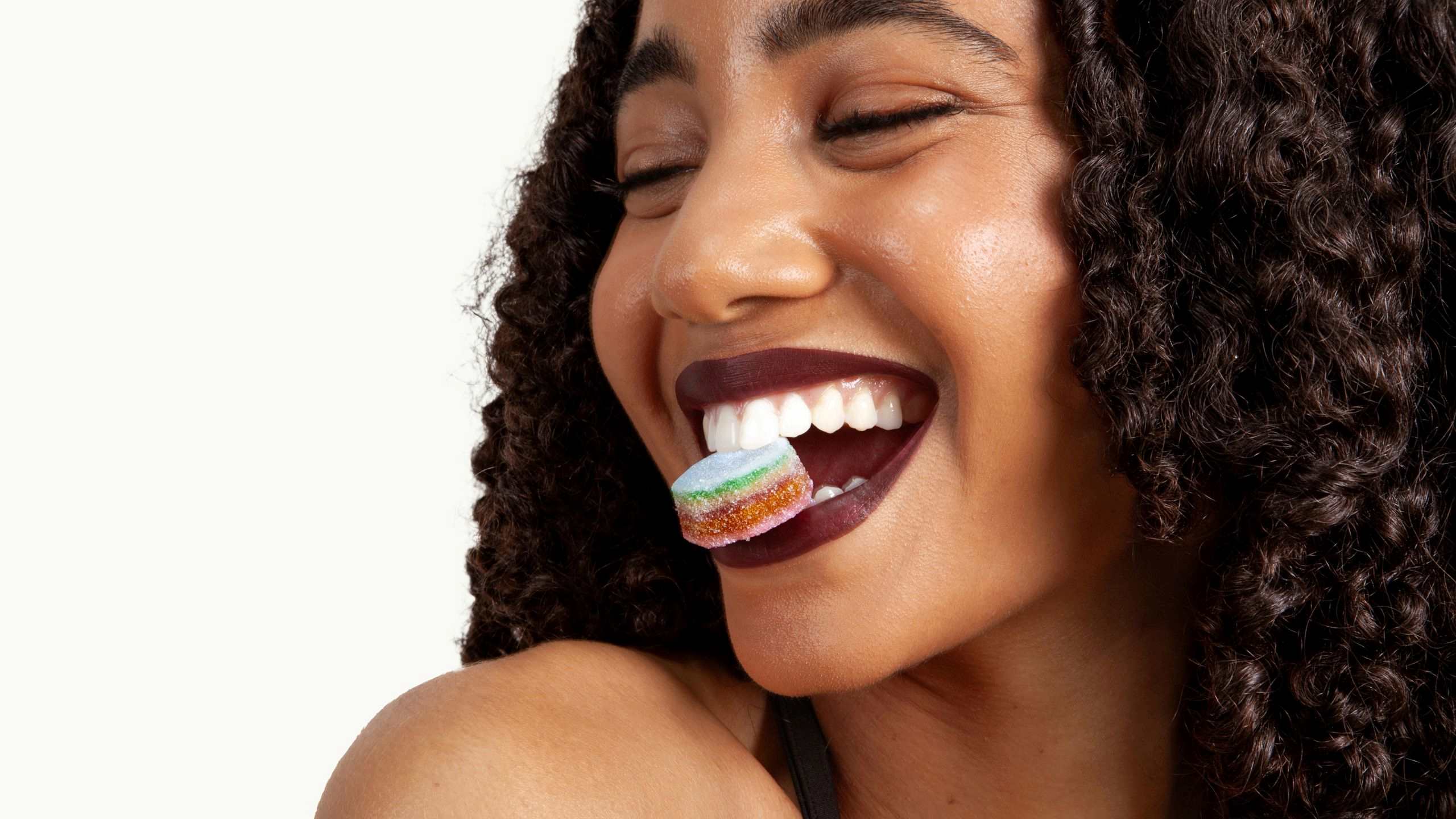 woman holding Elo Smart Gummies in her mouth